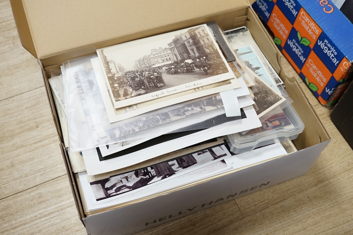 A collection of early 20th century postcards, photographs, etc. Including three albums of novelty postcards, scenes of London, etc. First World War postcards, etc. and an Edwardian photograph album, together with four bo